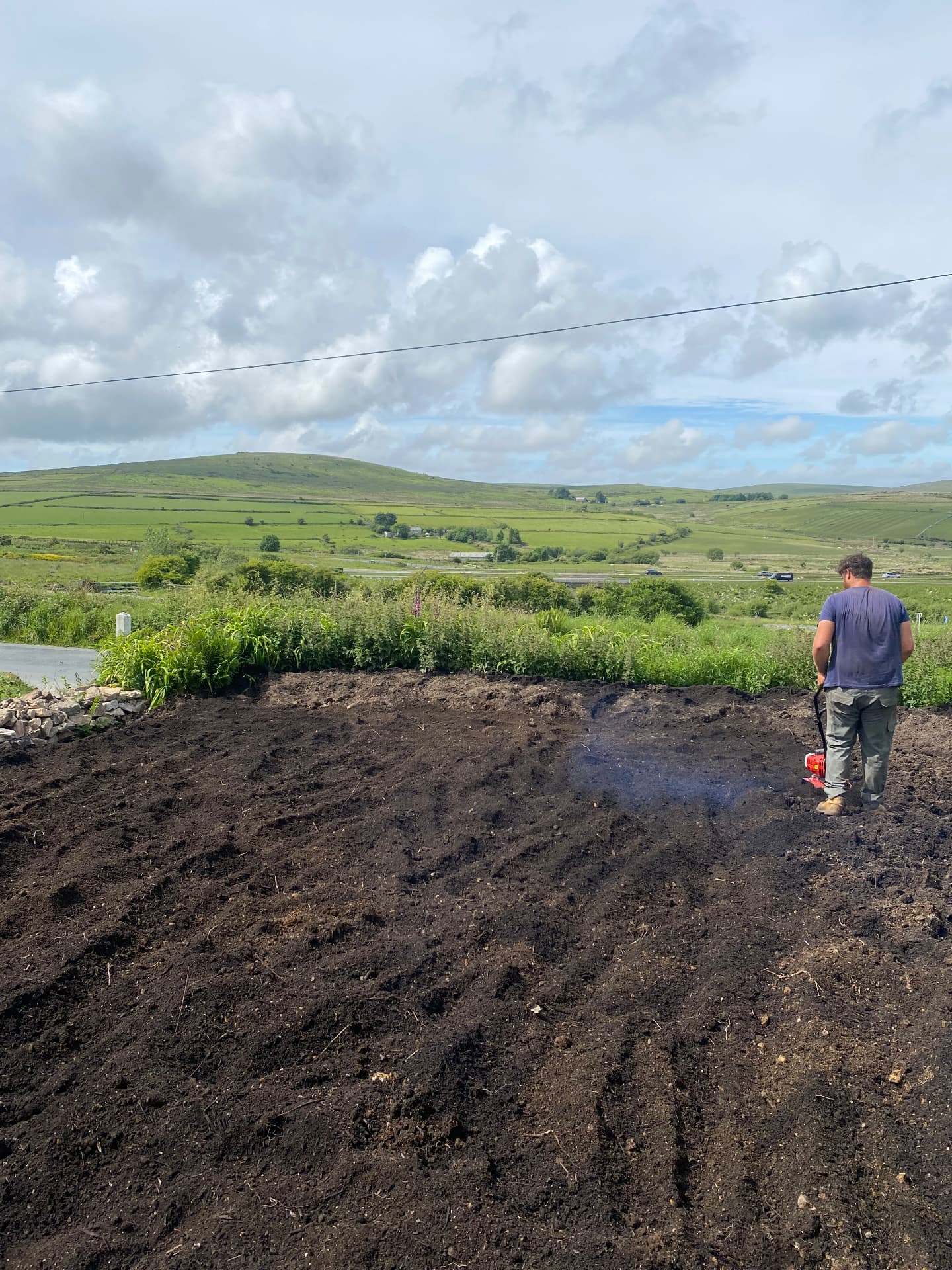 Compost rotavated into a moorland-edge garden bed